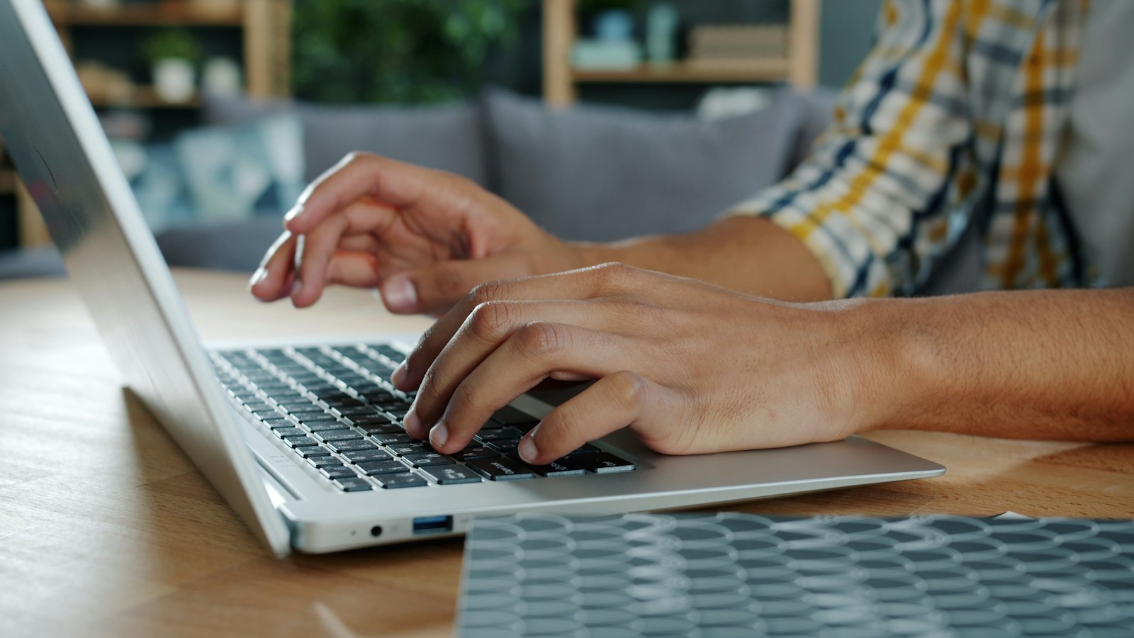 Close-up of hands typing on a laptop keyboard, representing self-paced ISO 9001 Ready e-learning